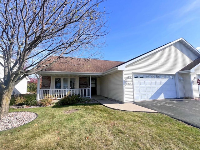 single story home with covered porch, a garage, and a front lawn