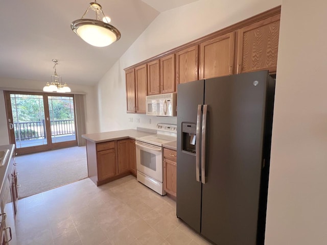 kitchen featuring kitchen peninsula, vaulted ceiling, a notable chandelier, light colored carpet, and white appliances