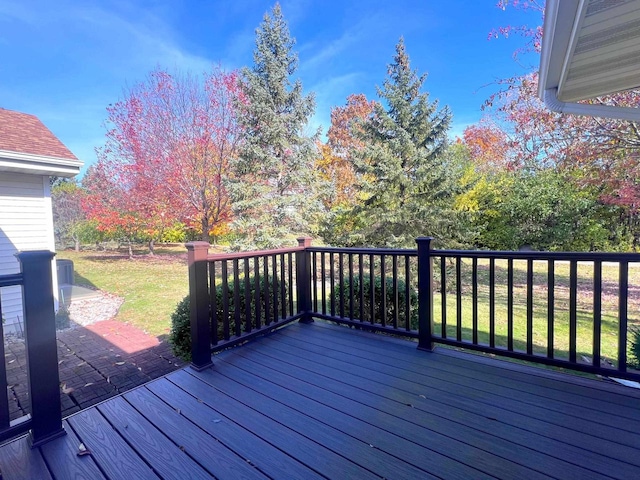 wooden deck featuring a lawn