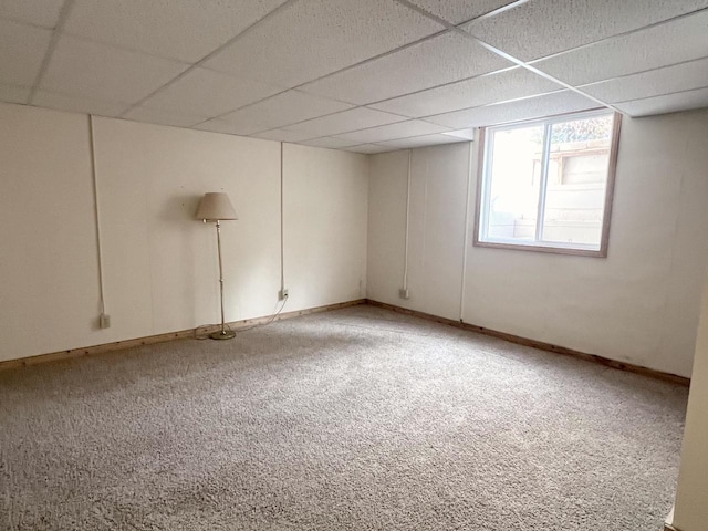 carpeted empty room with a paneled ceiling