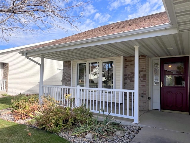 view of exterior entry featuring a porch