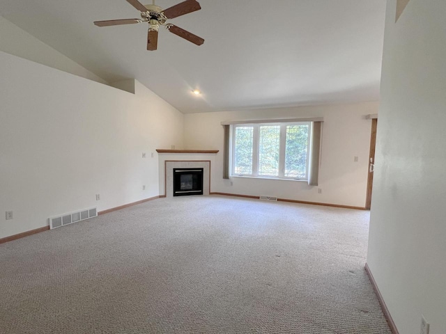 unfurnished living room featuring a fireplace, ceiling fan, carpet, and vaulted ceiling