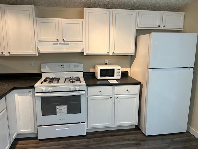 kitchen with white cabinetry, a textured ceiling, white appliances, and dark hardwood / wood-style flooring