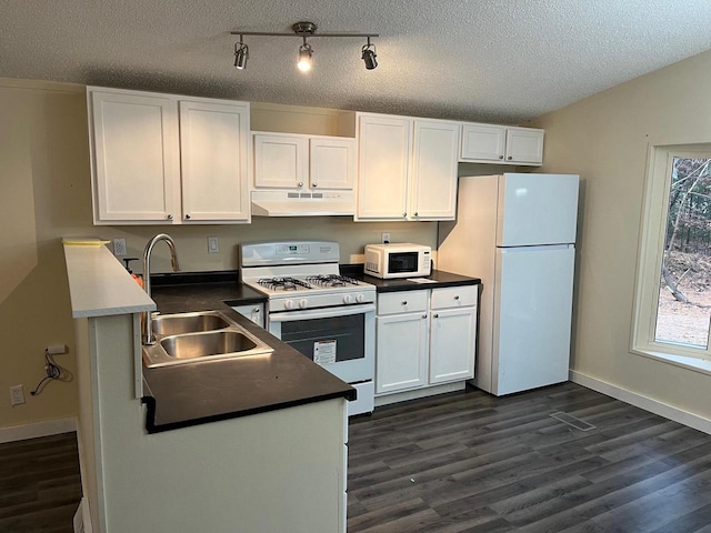 kitchen with dark hardwood / wood-style floors, white cabinetry, a textured ceiling, and white appliances