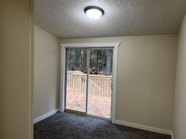 interior space featuring dark colored carpet and a textured ceiling