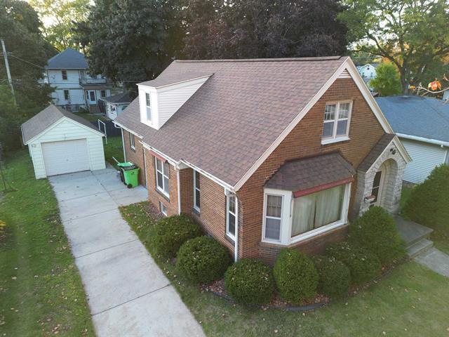 view of property exterior with an outdoor structure and a garage