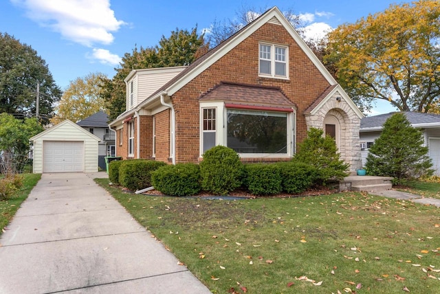 view of front of house with a front lawn, an outbuilding, and a garage