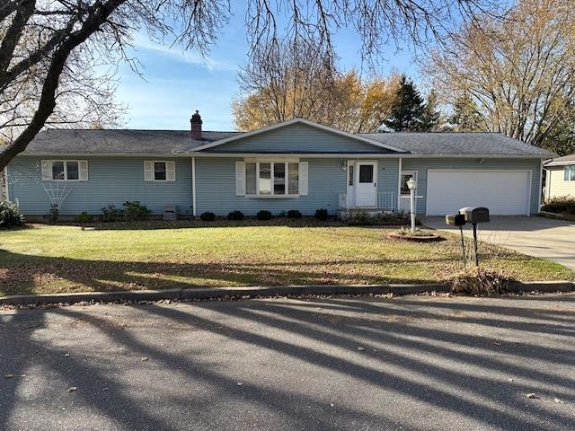 ranch-style home with a front lawn and a garage