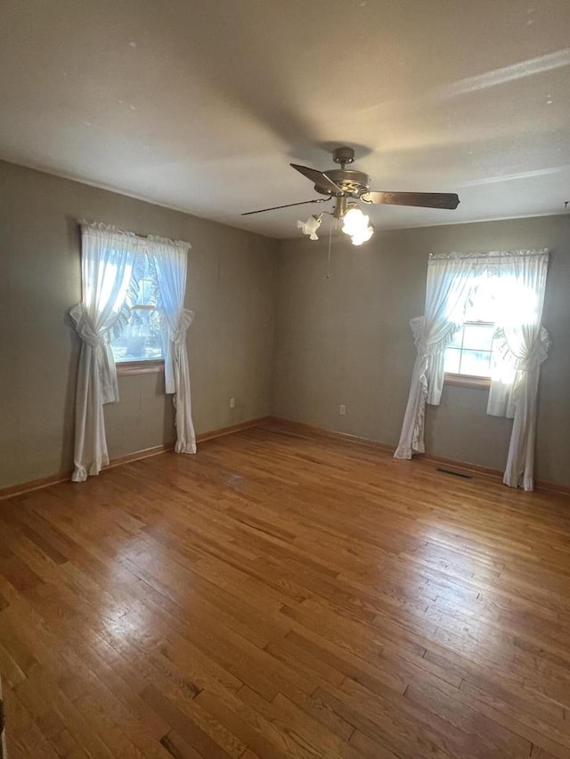 unfurnished room featuring hardwood / wood-style floors and ceiling fan