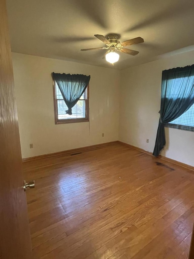 spare room with light hardwood / wood-style flooring and ceiling fan