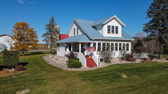 rear view of house with a yard and a porch