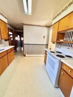 kitchen featuring white range with electric stovetop