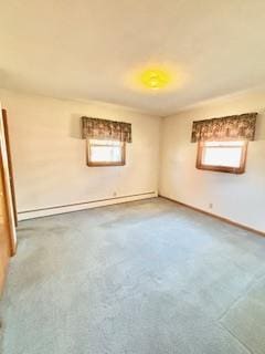 carpeted spare room featuring baseboard heating