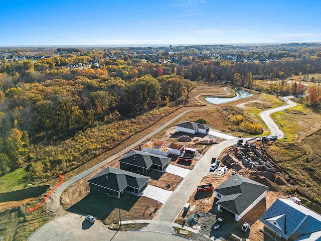 aerial view with a water view and a wooded view