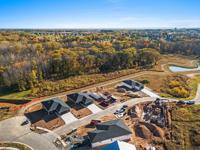 birds eye view of property with a view of trees