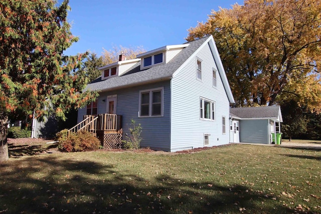 view of front of property with a chimney, a front lawn, and roof with shingles