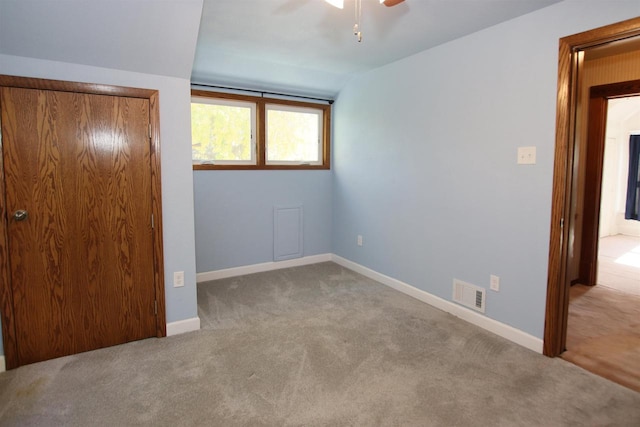 unfurnished bedroom featuring visible vents, baseboards, and carpet