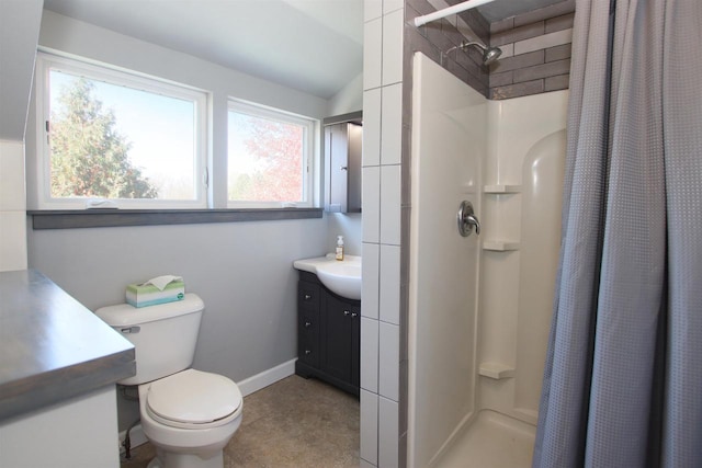 bathroom featuring baseboards, toilet, a stall shower, and vanity