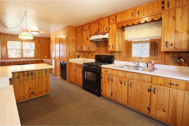 kitchen with under cabinet range hood, black range with gas stovetop, light countertops, and a sink