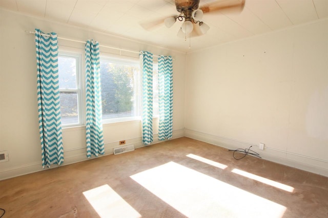 carpeted empty room with visible vents and ceiling fan