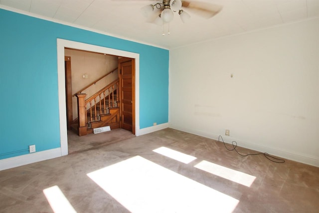 empty room with baseboards, visible vents, carpet floors, ornamental molding, and stairs