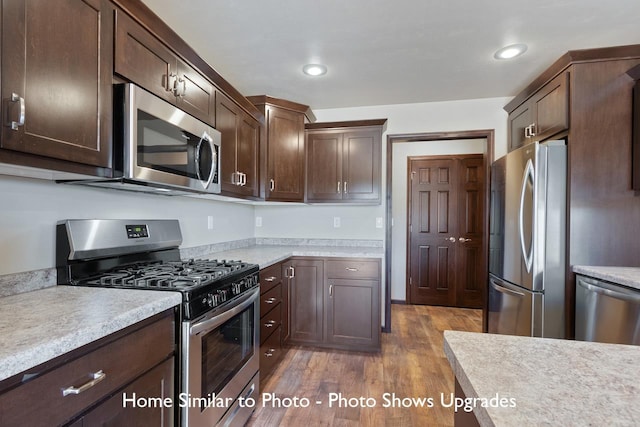 kitchen featuring appliances with stainless steel finishes, dark hardwood / wood-style floors, and dark brown cabinets