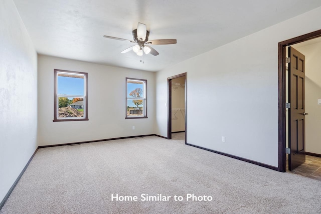 empty room featuring light colored carpet and ceiling fan