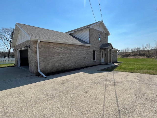 view of property exterior featuring a lawn and a garage