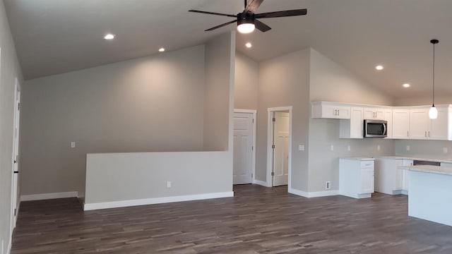 kitchen with high vaulted ceiling, white cabinets, pendant lighting, and dark hardwood / wood-style floors