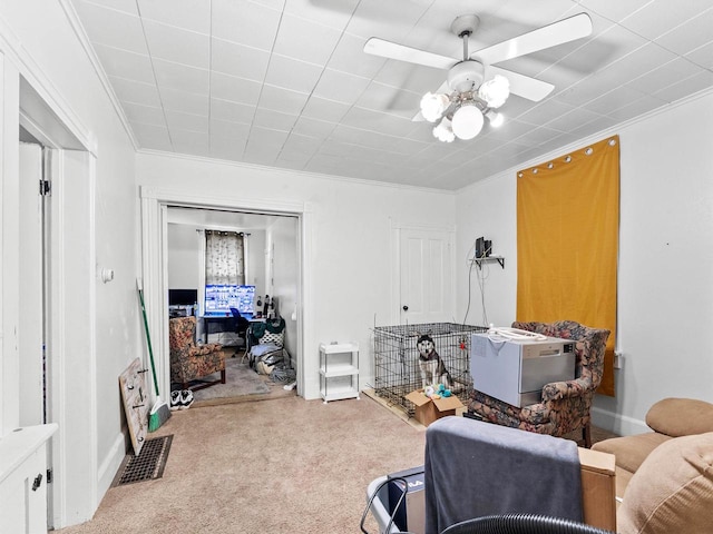 interior space with ceiling fan and ornamental molding