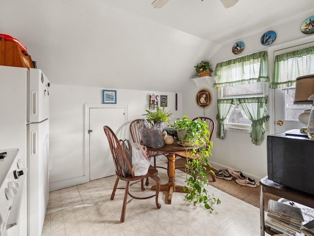 dining area featuring ceiling fan and vaulted ceiling