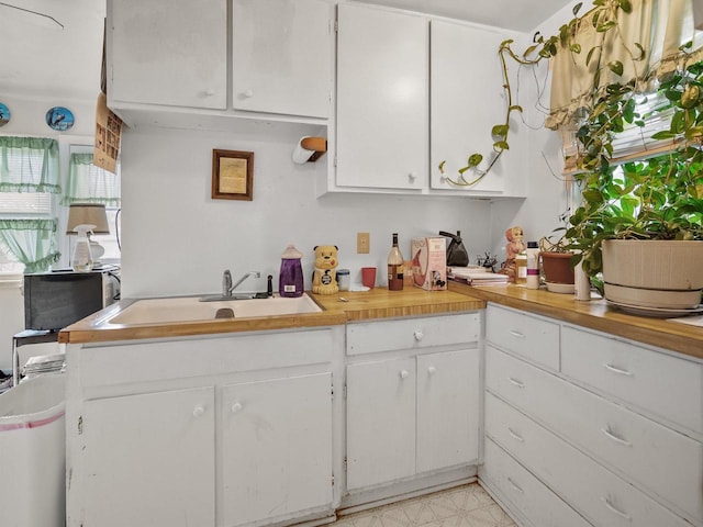 kitchen featuring sink and white cabinets