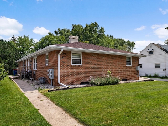 view of side of property with a yard