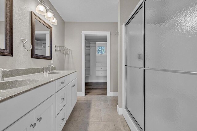 bathroom featuring vanity, tile patterned flooring, and an enclosed shower