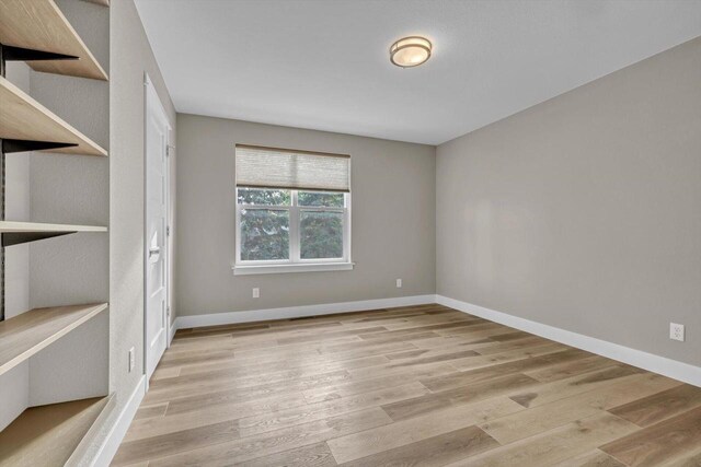 unfurnished room with light hardwood / wood-style floors