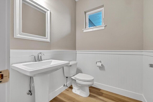 bathroom featuring hardwood / wood-style floors and toilet