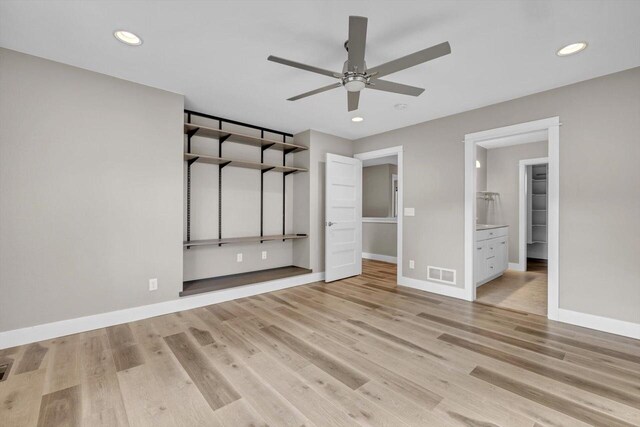 unfurnished bedroom with ceiling fan, light hardwood / wood-style flooring, and ensuite bath