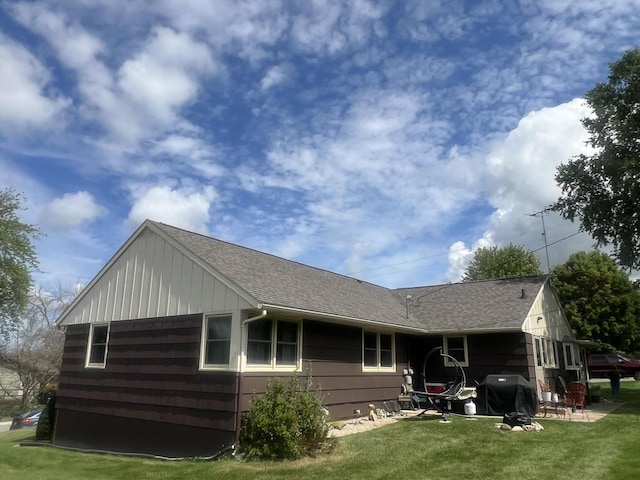 back of house featuring a lawn and a patio area