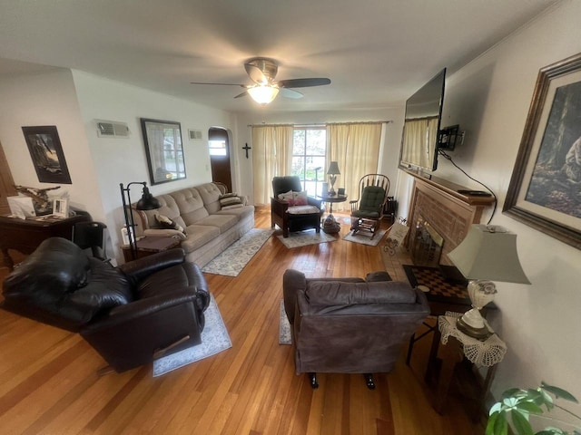 living room featuring light hardwood / wood-style floors and ceiling fan