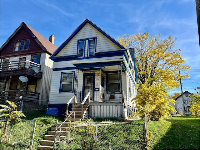 view of front facade with covered porch and a front lawn