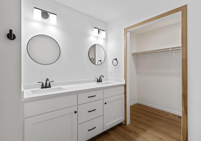 bathroom with vanity and hardwood / wood-style floors