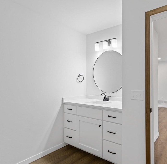 bathroom with vanity and hardwood / wood-style flooring