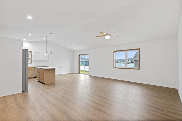 unfurnished living room featuring light hardwood / wood-style flooring, lofted ceiling, and ceiling fan