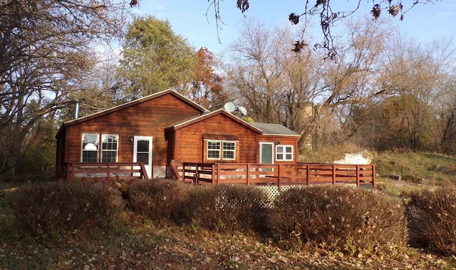 back of house with a deck