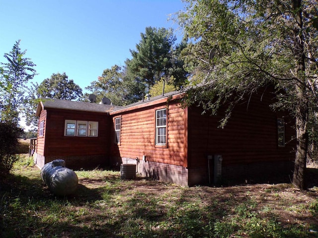 view of side of property featuring central AC