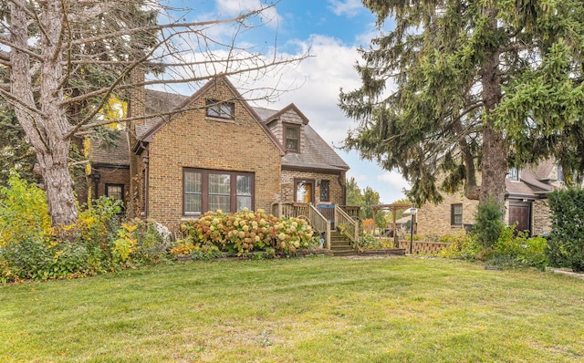 english style home with a front lawn