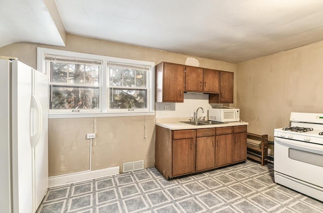 kitchen with white appliances and sink