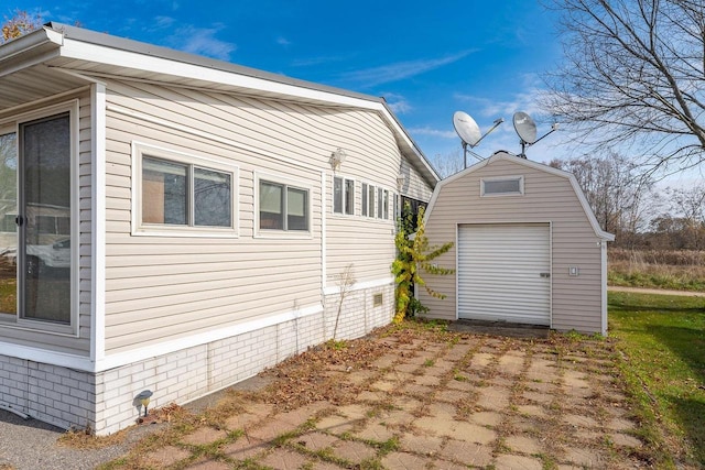 view of property exterior featuring an outbuilding and a garage