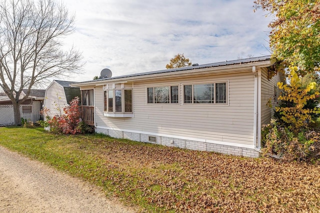 view of side of home featuring a yard