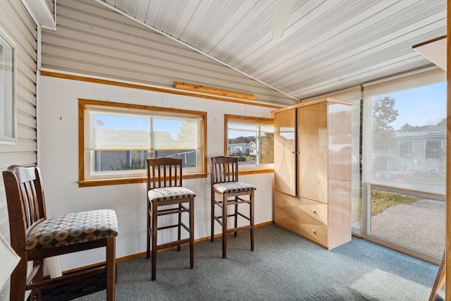 sunroom / solarium featuring vaulted ceiling and wooden ceiling